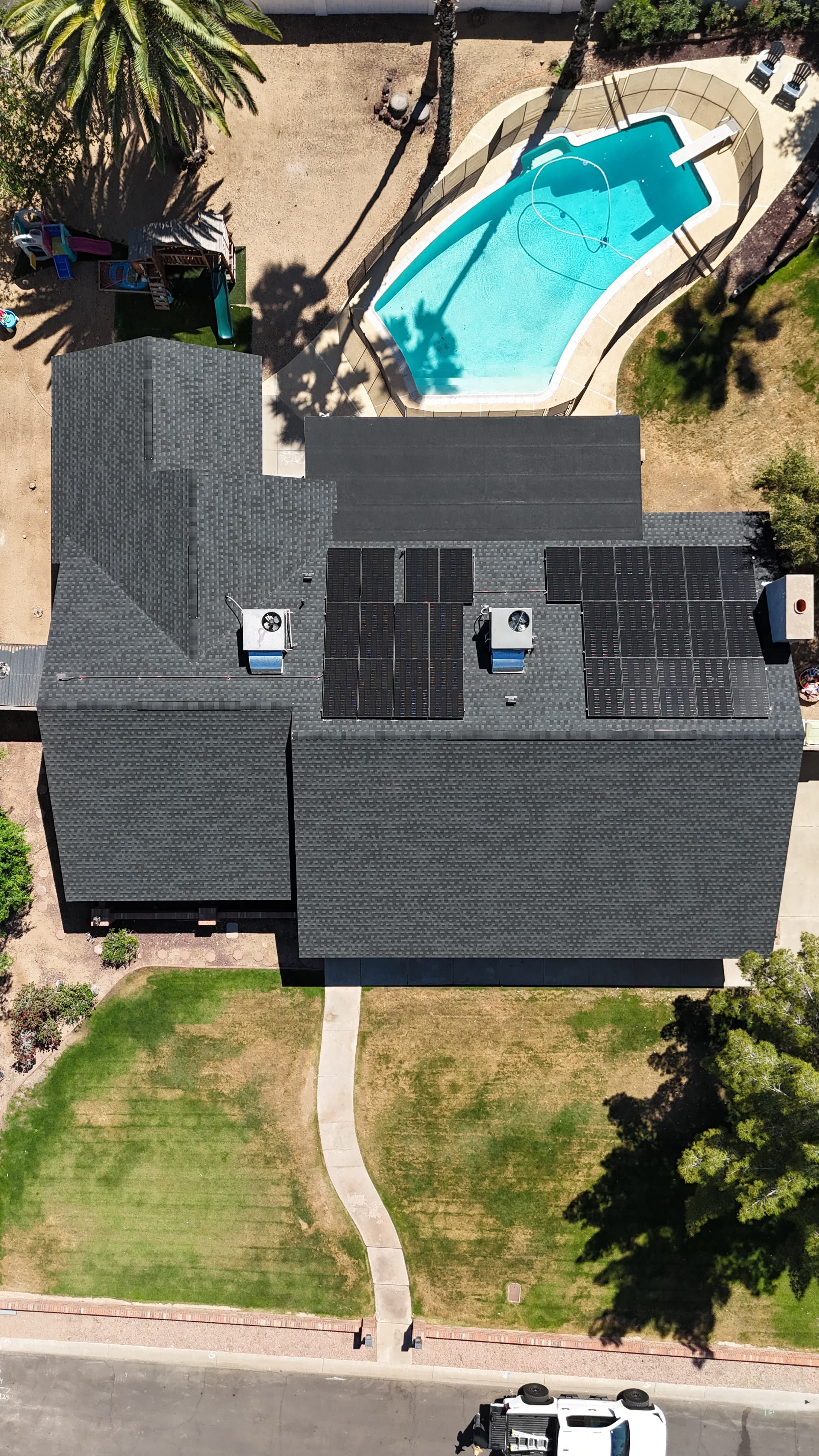 Completed architectural shingle reroof in Glendale, AZ with the solar panel arrays detached and reset