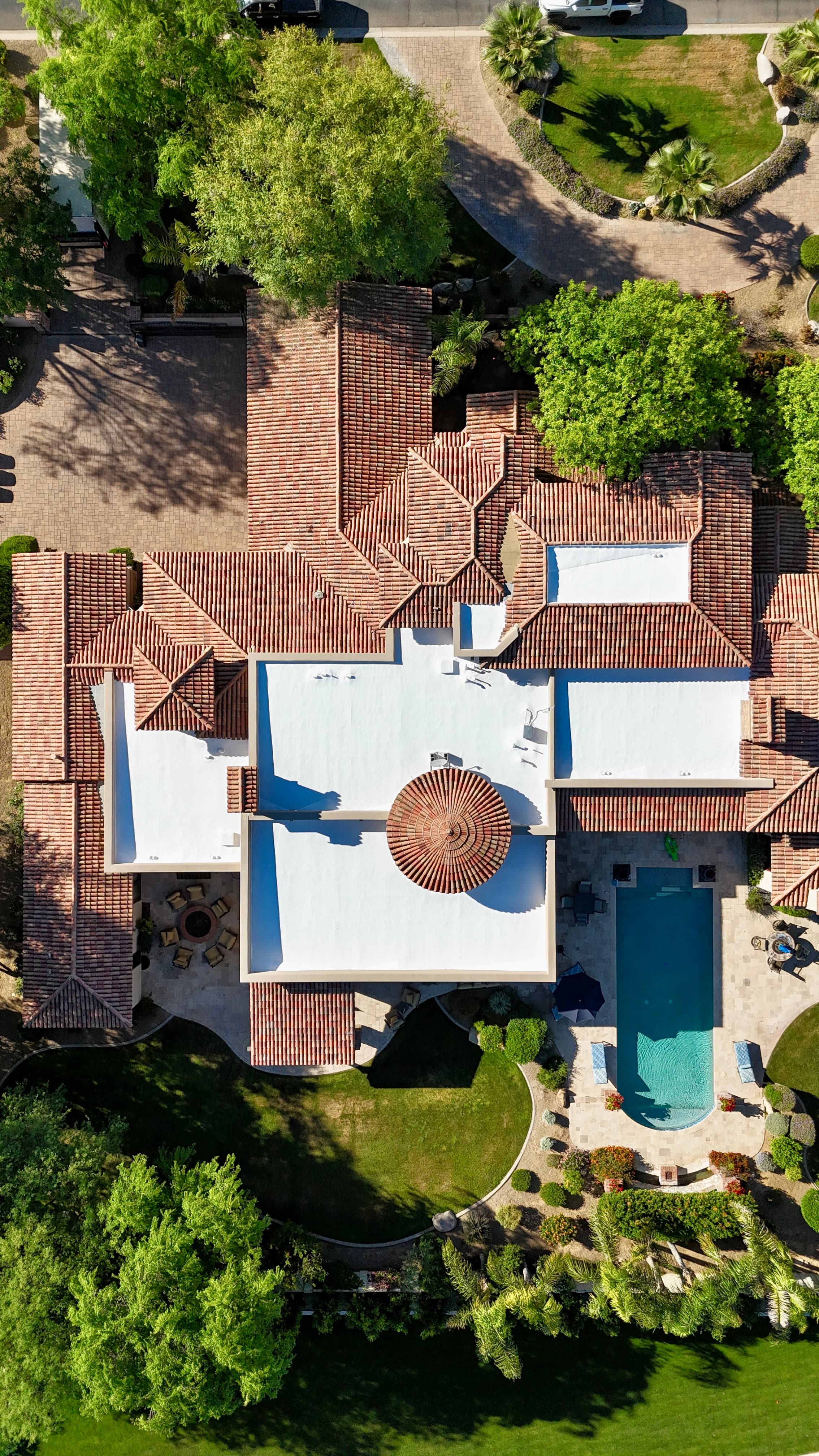 Large Paradise Valley, AZ estate showing barrel-tile roof sections alongside white flat foam recoat areas